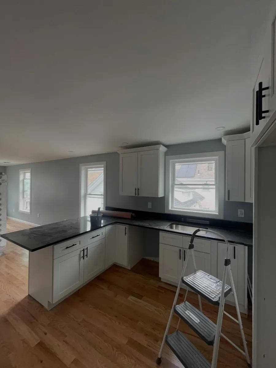 Kitchen with white cabinets and new floor