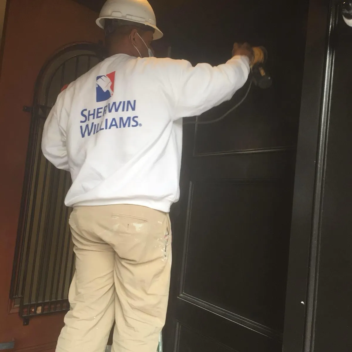 WRP painter finishing a dark front door
