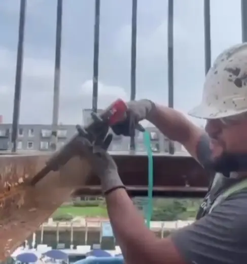 Scraping rust off a metal railing